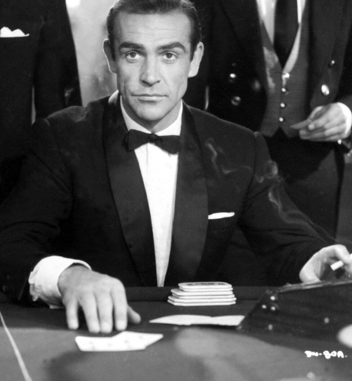Sean Connery as James Bond playing Baccarat at a casino table game